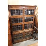 An oak four-section case enclosed leaded glazed doors with inscribed plate dated 1924, 35" wide