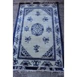 A Chinese contour pile rug with blue and white floral design, 74" x 47" approx