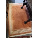 A peach ground, contour pile rug, 68" x 47" approx, and a Caucasian tribal rug with pink central