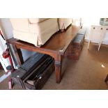 An Oriental hardwood dining table with planked top, on square supports, 42" x 86"