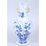A Chinese Kangxi period porcelain blue and white baluster vase, with two handles (one with a