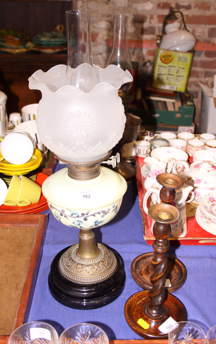 A late 19th century glass and brass oil lamp, 24" high, and a pair of 19th century oak barley