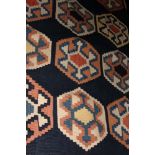 A mid 20th century kelim rug in shades of red, blue and natural, 77" x 59" approx