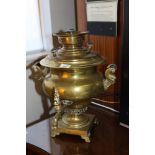 A late 19th century brass samovar with ebonised handles