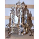 A George III silver Warwick five-section cruet stand, on shell feet, a matching sugar shaker, one