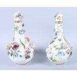 A pair of late 19th century Derby porcelain flower encrusted bottle vases and covers, 10" high