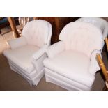 A pair of tub shaped arm chairs with loose seat cushions, upholstered in a pink fabric