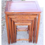 A nest of four Chinese carved hardwood occasional tables, on shaped and stretchered supports, 20"