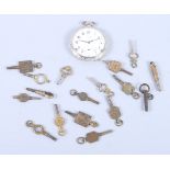 A silver cased open faced pocket watch and a large number of pocket watch keys, various