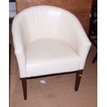 A pair of cream leather tub shaped chairs, on square taper supports