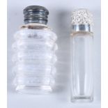 A glass scent bottle with floral embossed silver lid and a 19th century ribbed glass scent bottle