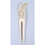 A 19th century Canton ivory hair ornament, with pierced handle decorated roaming dragon, 10 1/4"
