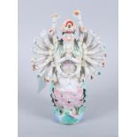 A Chinese porcelain model of 1000 arm Guan Yin, seated on a lotus, 8 3/4" high