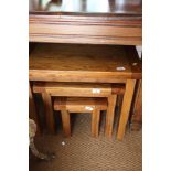 A nest of three oak occasional tables, largest 26" wide