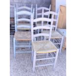 A set of five painted pine ladder back chairs with rush envelope seats