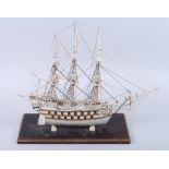 A 19th century Prisoner of War bone scale model of a thirty-two gun two-deck ship, with planked