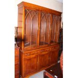 A yew wood display cabinet, the upper section enclosed three Gothic lattice glazed doors over