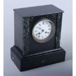 A late 19th century slate mantel clock with eight-day striking movement and white enamel dial, 10