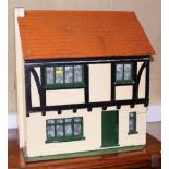 An early 20th century painted wooden fitted dolls house, based on a property in West Wycombe,