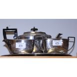 A silver plate three-piece tea set and a circular tray