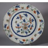 An 18th century London delft charger with sprays of flowers decoration, 13 1/4" dia (hair crack)