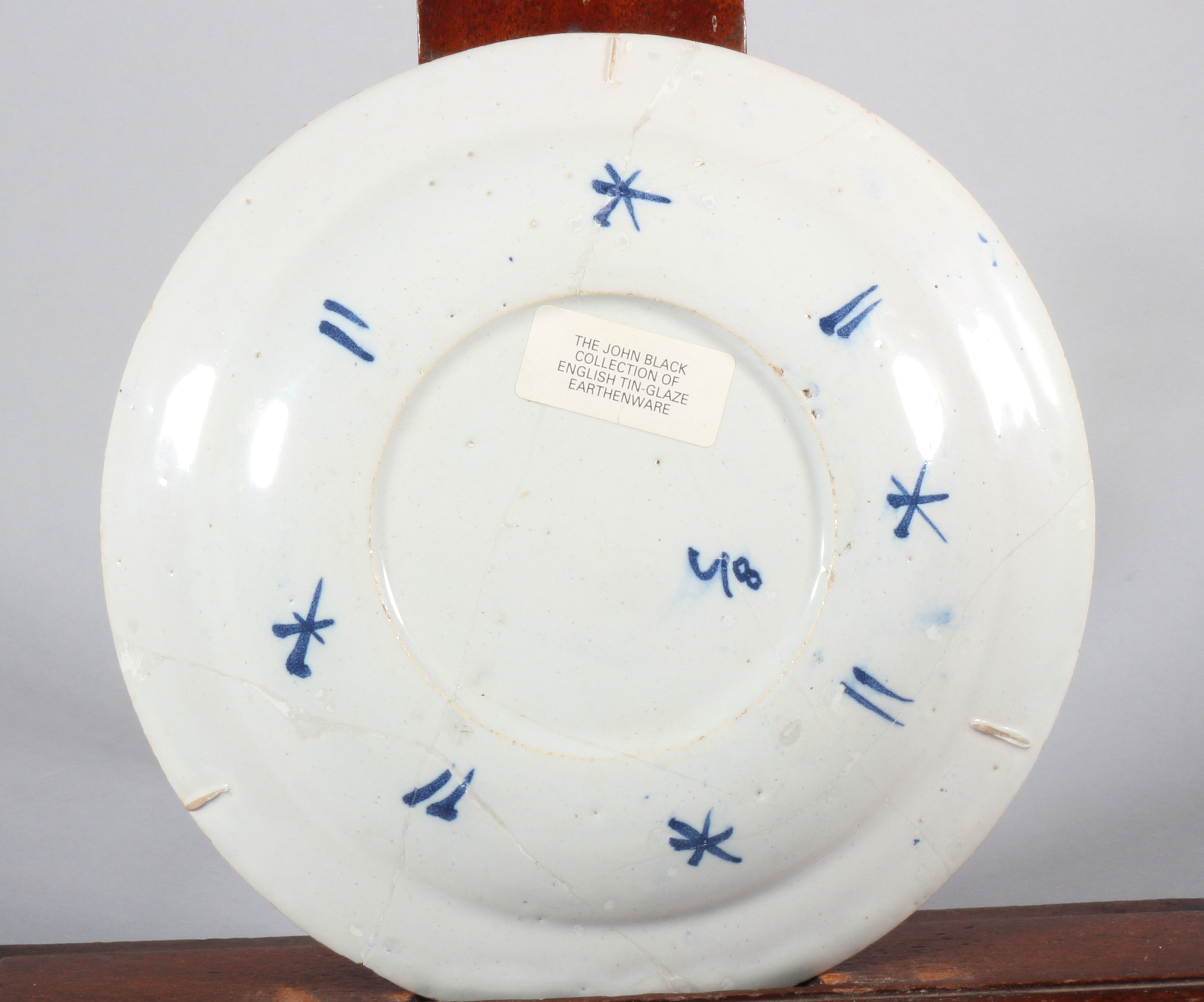 An early 18th century Bristol delft plate with swag and scroll decoration, inscribed monogram " - Image 3 of 3