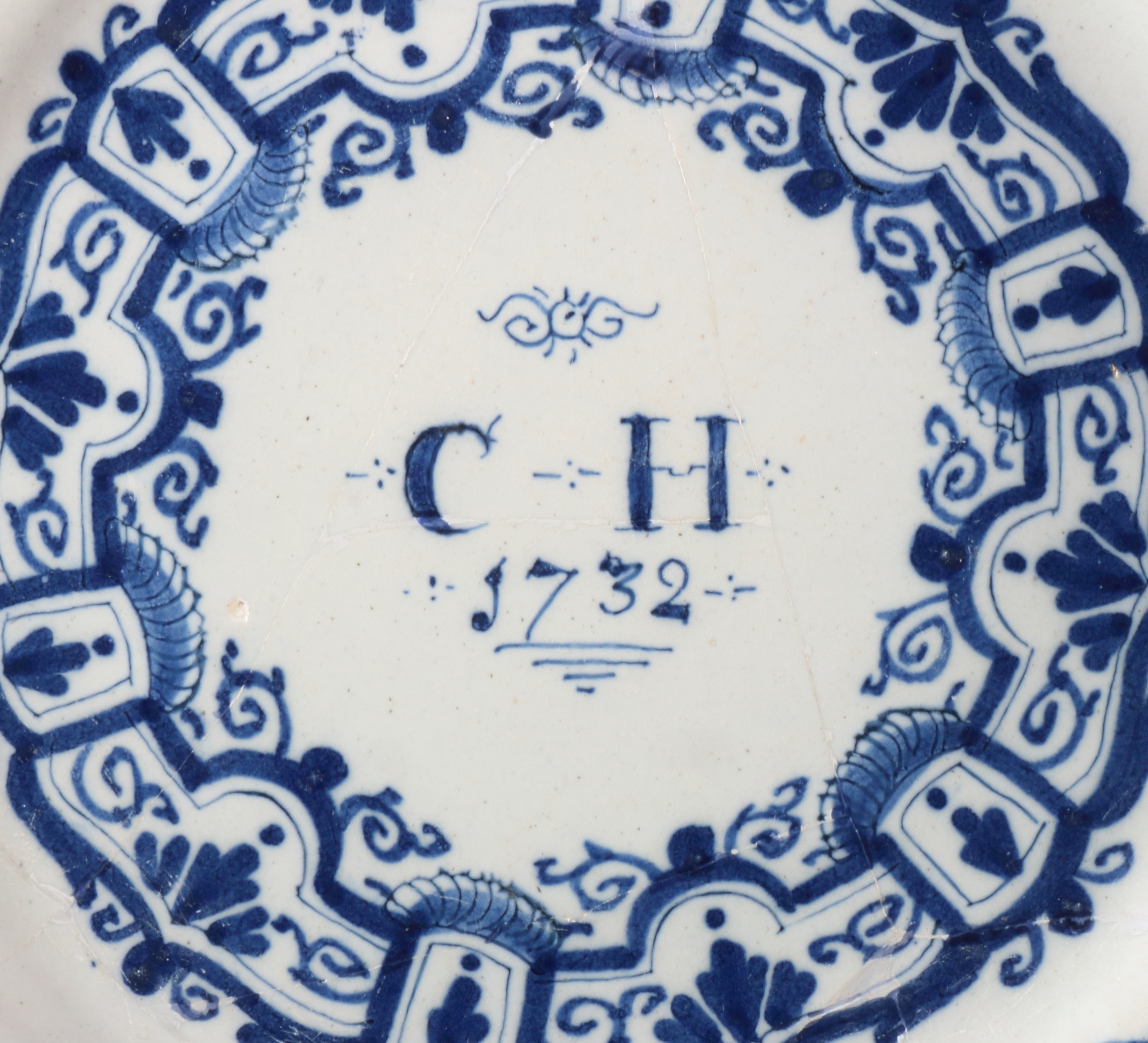 An early 18th century Bristol delft plate with swag and scroll decoration, inscribed monogram " - Image 2 of 3
