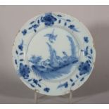 An 18th century English delft plate with birds in landscape decoration, 8 5/8" dia (rim restored)