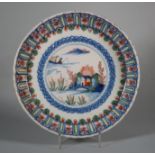An 18th century English delft polychrome shallow lobed bowl with boat and fisherman in landscape