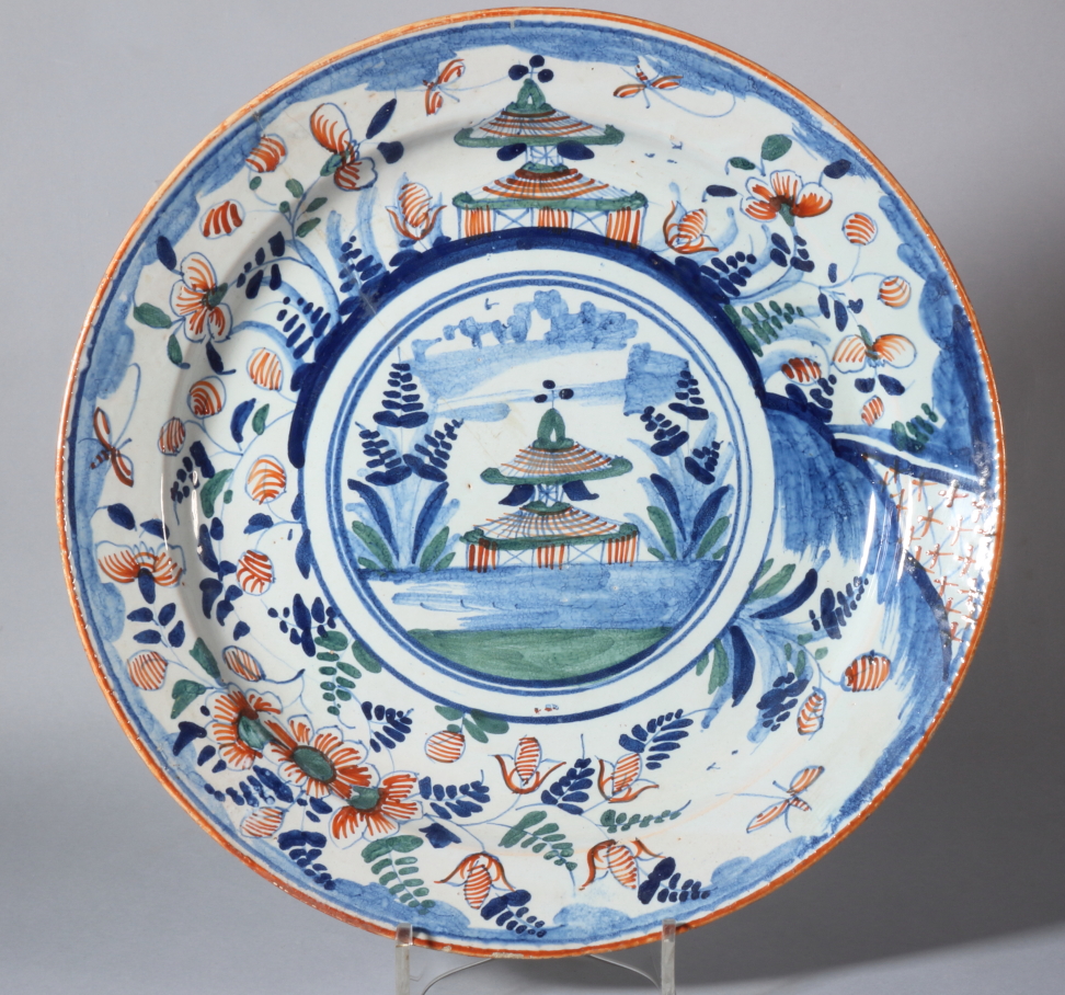 An 18th century Bristol delft charger with pagoda and landscape decoration and insect border, 13"