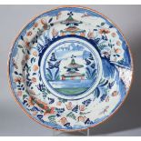 An 18th century Bristol delft charger with pagoda and landscape decoration and insect border, 13"