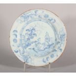 An 18th century Liverpool delft plate with landscape and figures decoration, 8 3/8" dia (old staples