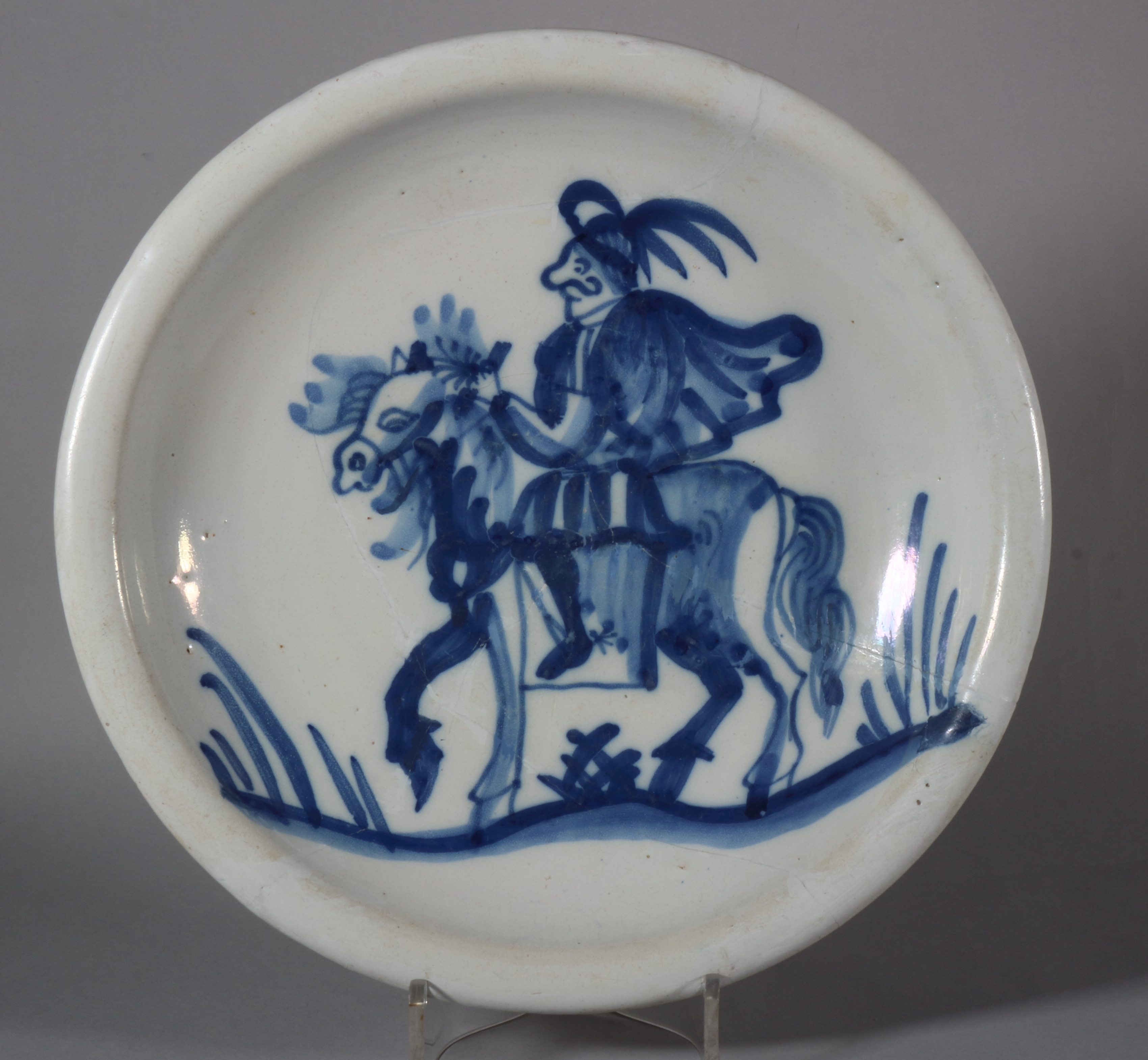 An 18th century Dutch delft shallow bowl with horse and rider decoration, 12 1/4" dia (old