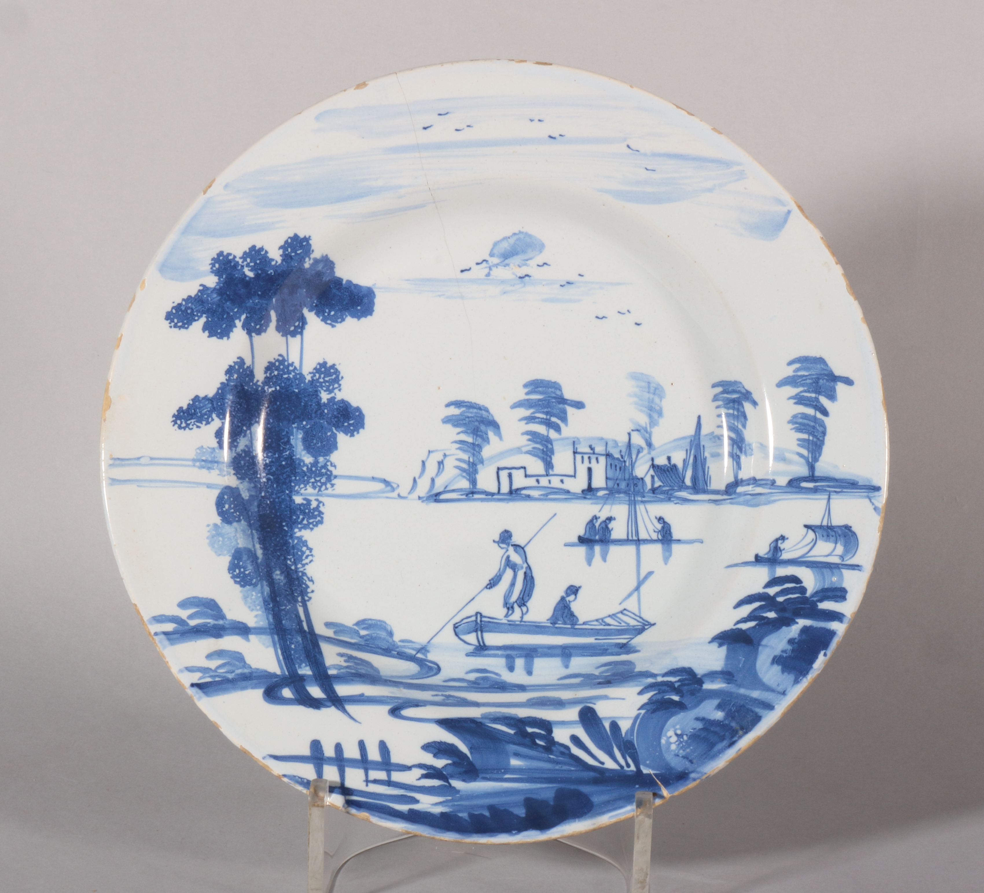 An 18th century Bristol delft plate with landscape with small boats and distant castle decoration, 8