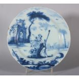 An 18th century Lambeth delft plate with shepherd and shepherdess in landscape and distant arch