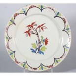 An 18th century English delft plate with polychrome bamboo centre, 8 7/8" dia (stabilised crack)