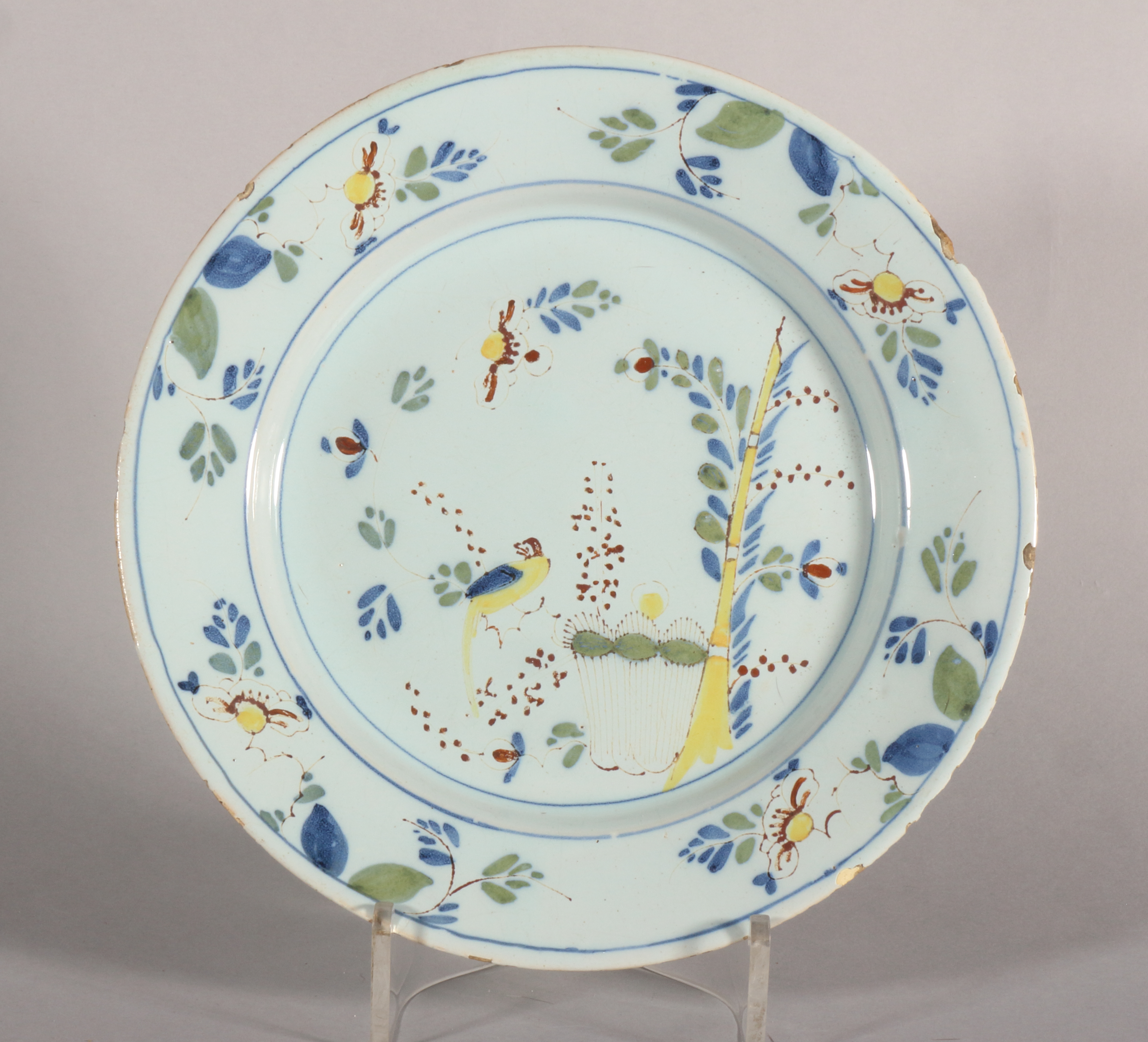 An 18th century English delft polychrome plate with parrot and bamboo decoration, 8 7/8" dia, c1750