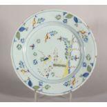 An 18th century English delft polychrome plate with parrot and bamboo decoration, 8 7/8" dia, c1750