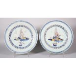 A pair of 18th century London delft plates with polychrome chinoiserie landscape centres and