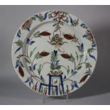 An 18th century English delft charger with insect and vase of flowers decoration, 13" dia (