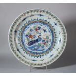 An 18th century Bristol? delft charger with peacock decoration, foot rim with two holes, 13" dia (