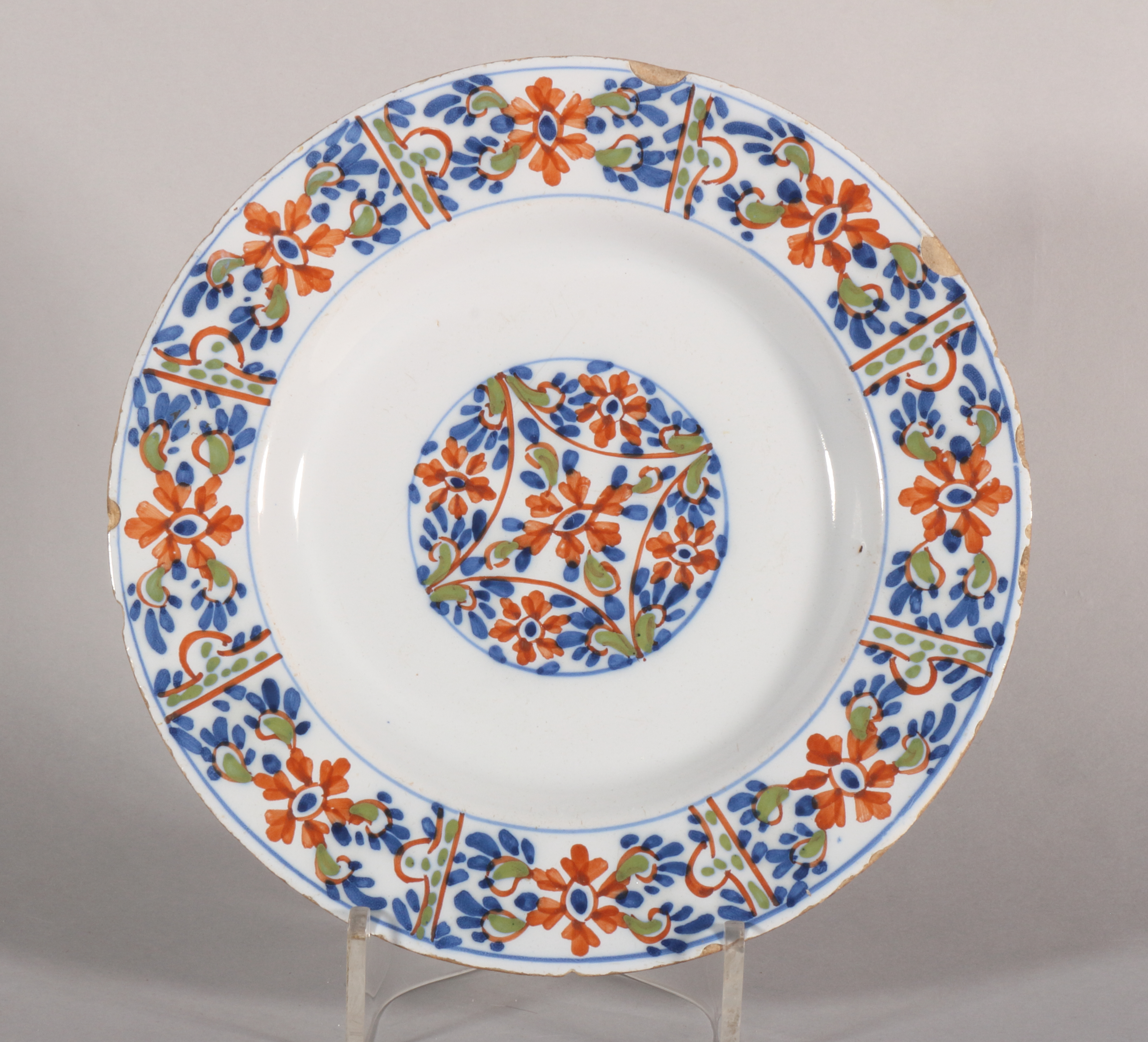An 18th century Scottish/Lambeth? delft polychrome plate with geometric floral decoration, 9" dia [