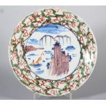 An 18th century English delft plate with polychrome landscape with rock and boat decoration and "