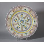 An 18th century English delft charger with manganese sponged decoration, 13" dia (restored - large