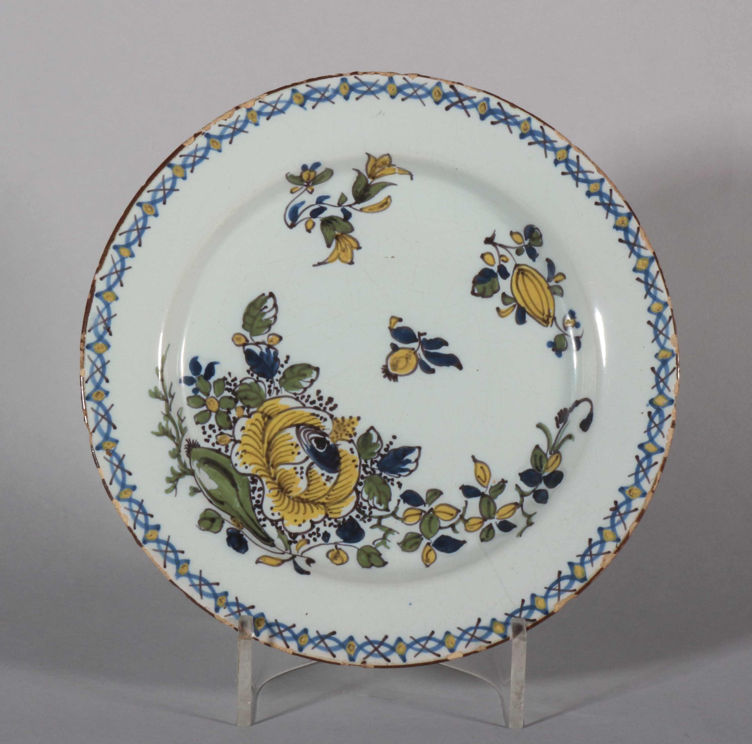 An 18th century Lambeth delft polychrome plate with floral spray decoration, 8" dia (hair crack)