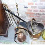 A brass coal helmet, three fire irons, a copper warming pan and other metal wares