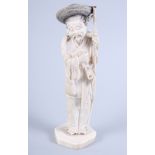 A Japanese Meiji period carved ivory figure of an elderly man with staff and basket, his hat and