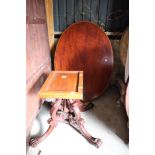 A 19th century mahogany oval loo table, on carved central column and carved scroll end supports with