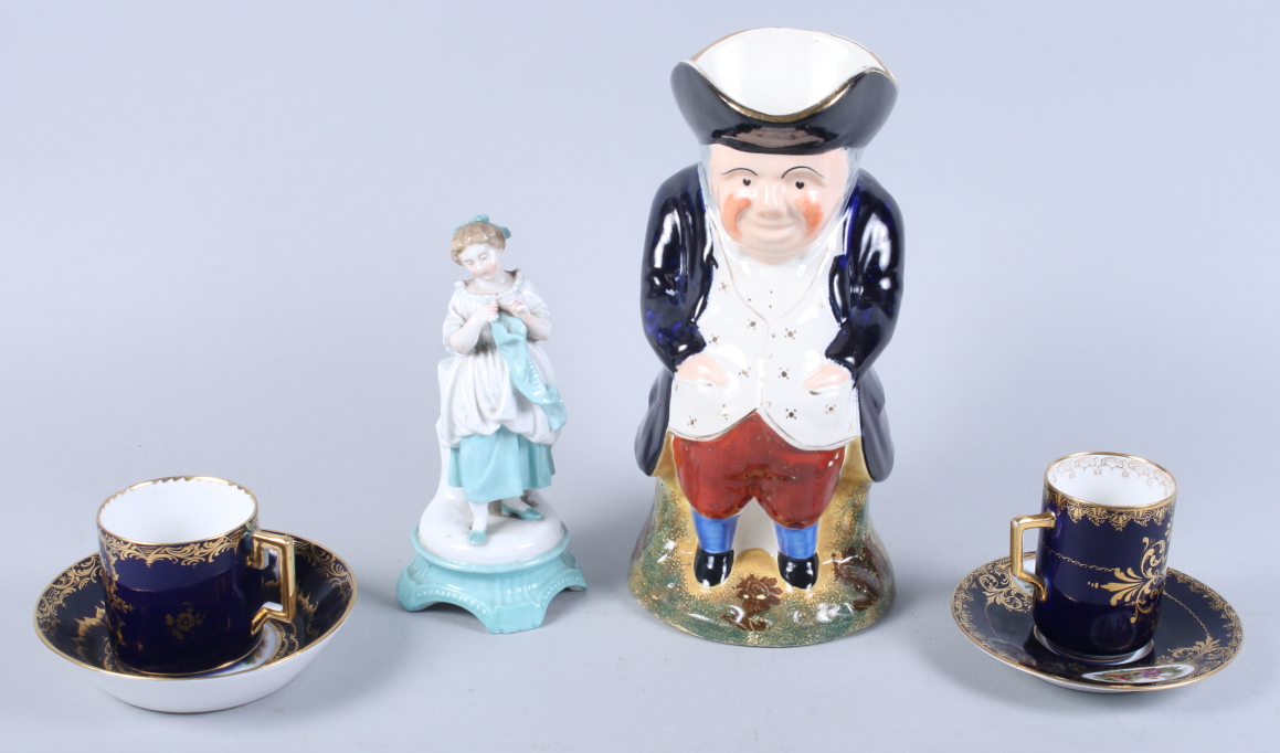 Two Vienna porcelain coffee cans and saucers decorated figures on a blue ground with gilt