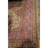 A Persian design rug with all-over floral design in shades of pink, green and natural, 124" x 108"